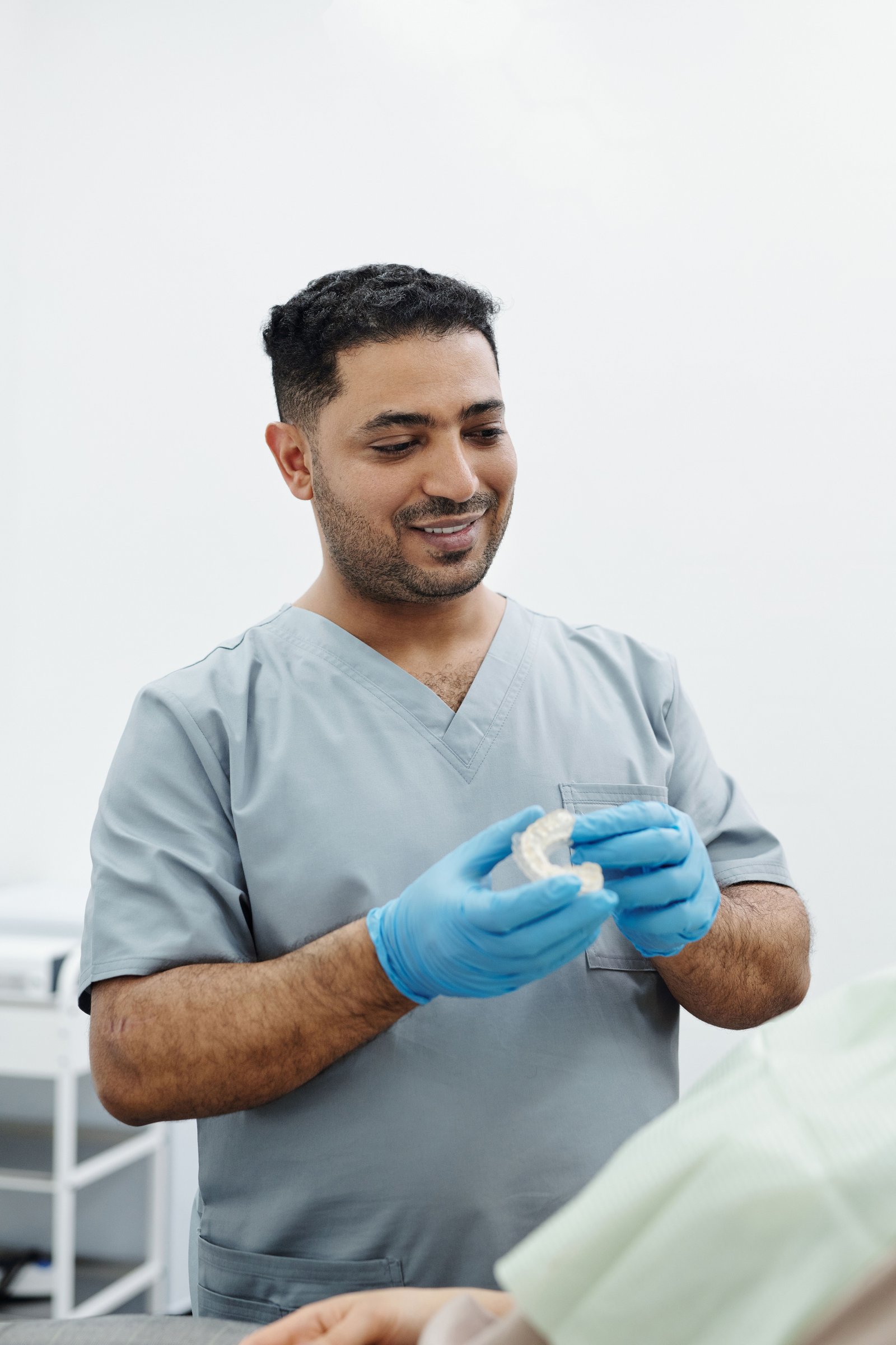 Patient cleaning a mouthguard